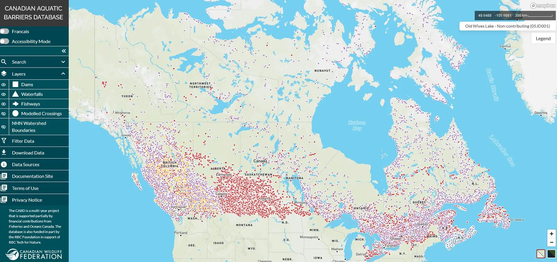 The CABD web application at aquaticbarriers.ca: a map of Canada dense with colour-coded dam, waterfall and fishway records, with layer controls on the left.